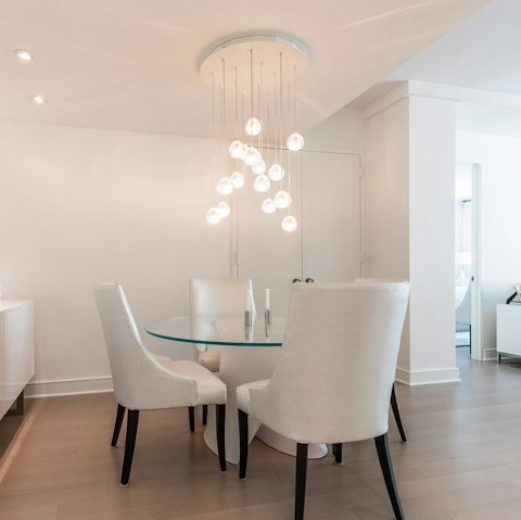 Dine underneath the hanging orb light in the living area