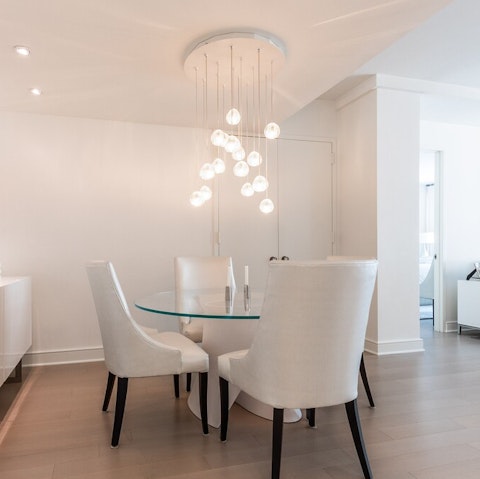 Dine underneath the hanging orb light in the living area