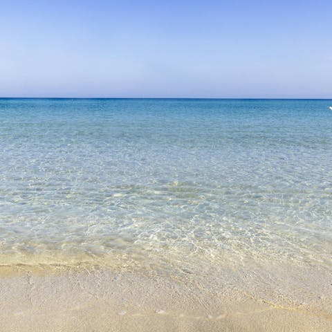Pack a beach bag and walk to the bay of Porto Ulisse
