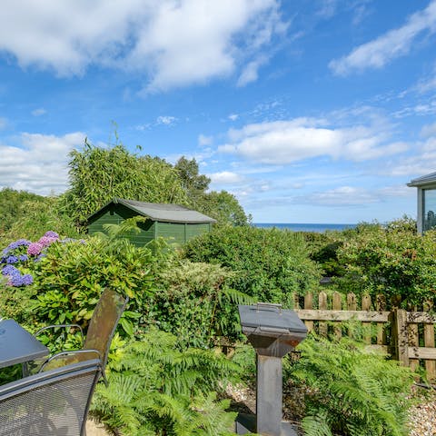 Enjoy an alfresco feast in the garden and admire sea views