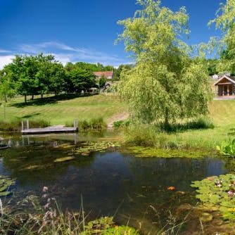 While away the hours in the sunshine by one of the two large ponds