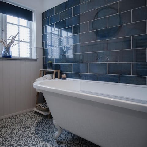 Treat yourself to a long soak in the freestanding tub after a day by the coast