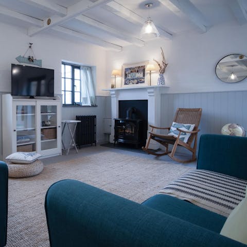 Cosy up by the living room's fire on cooler evenings