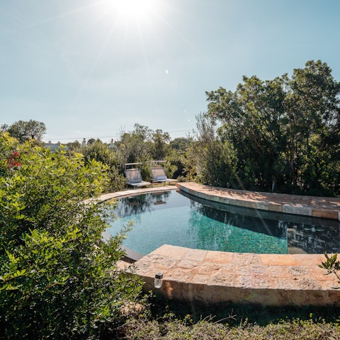 Doze in the sunshine beside the private pool