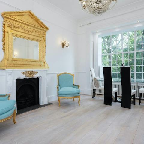Admire the chandelier, Louis XV chairs and gold furniture of this French-Palais-style home