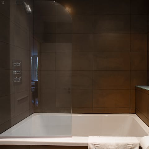 Treat yourself to an indulgent soak in the sleek bathtub