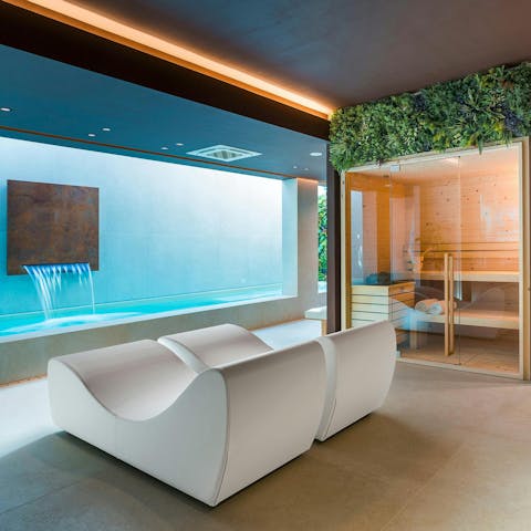 Unwind in the private spa with a sauna and heated pool