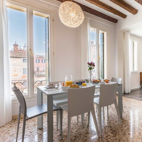 Gather for Venetian-inspired meals at the dining table, from where you can gaze out at the canal
