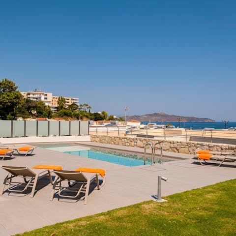 Catch glimpses of the Mediterranean as you relax on a lounger