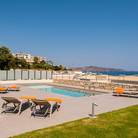 Catch glimpses of the Mediterranean as you relax on a lounger