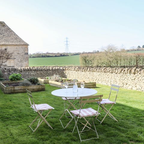 Take in the views over the Cotswold countryside from the small, walled garden
