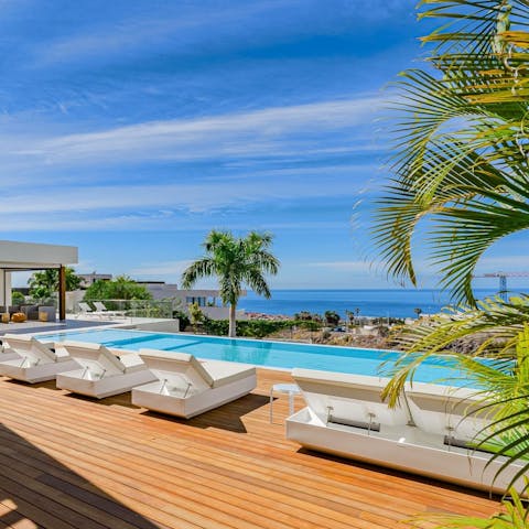 Relax by the private pool and soak up the sea view