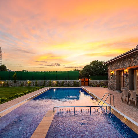 While away summer evenings in the garden, dipping in and out of the swimming pool