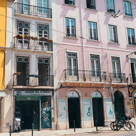 Explore Bairro Alto's cobblestone streets lined with Fado bars, fifteen minutes away by bus