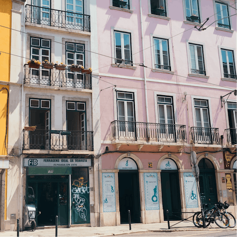 Explore Bairro Alto's cobblestone streets lined with Fado bars, fifteen minutes away by bus