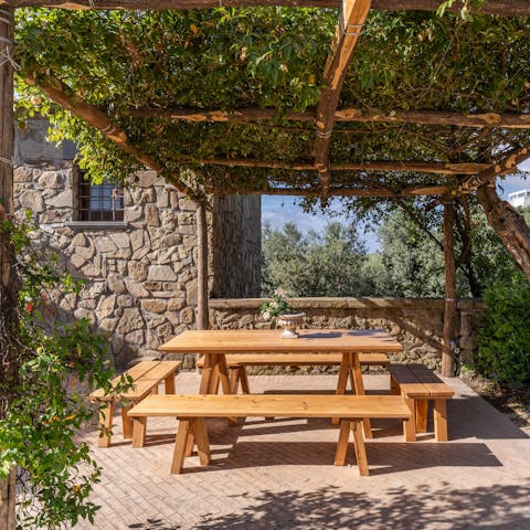 Gather under the pergola for dinner and drinks alfresco