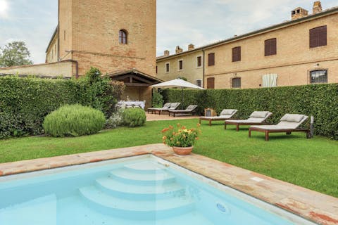 Admire views of the 13th-century tower while hopping into the seasonal pool