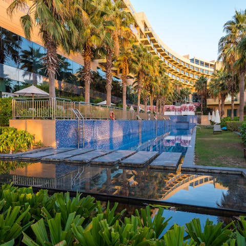 Unwind with a swim in the resort's palm-lined pool