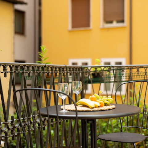 Catch the last of the sun with aperitifs on the private balcony