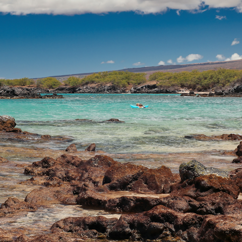 Stay a ten-minute drive from scenic Waialea Beach