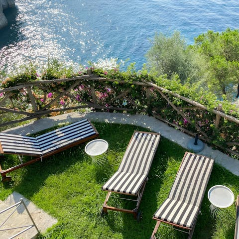 Soak up the sun and sea views beside the outdoor pool