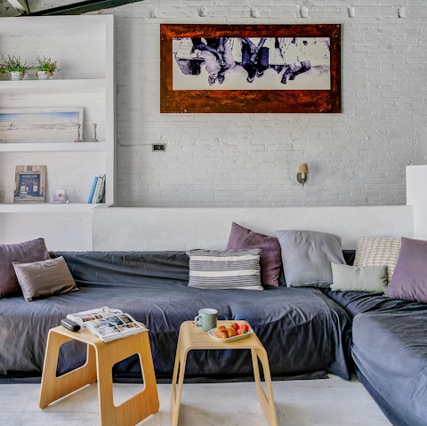 Cosy up on the huge sofas in the bright living room