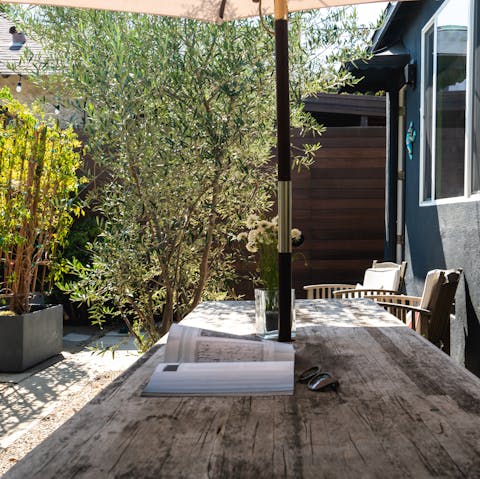 Sit out in the sun-dappled garden with your morning coffee, or seek shade under the parasol