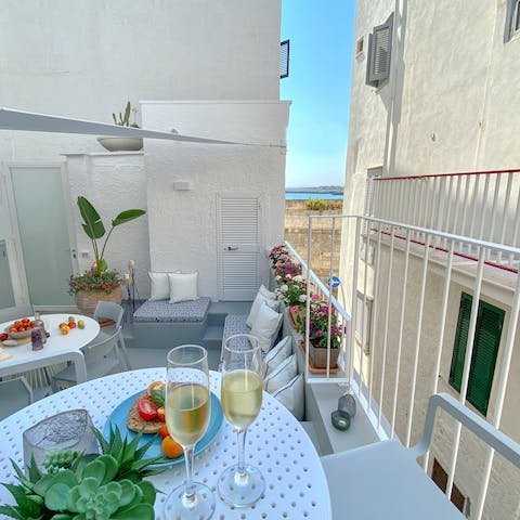 Sip local wine under the sun or stars and look out toward the sea
