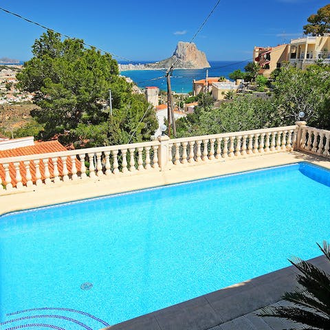 Sip a glass of something cold overlooking the pool and Peñón de Ifach