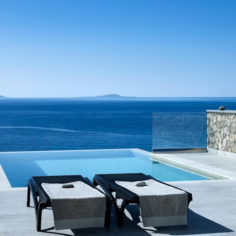 Gaze out to the Aegean Sea from the infinity pool