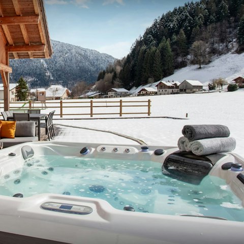 Soak in the hot tub as you drink in the mountain views
