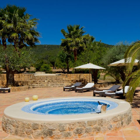 Relax in the sunken stone jacuzzi