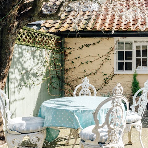 Enjoy a glass of Suffolk wine in the flower and herb filled courtyard