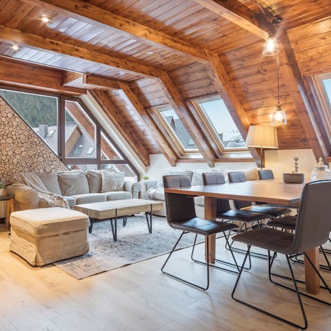 Dine and lounge in the open living room, flooded with natural light