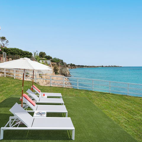 Lie back and listen to the waves as you relax on a lounger
