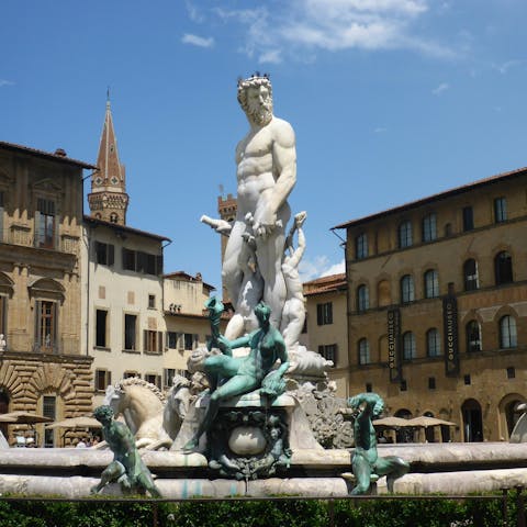 See the Fountain of Neptune, located only a short walk away