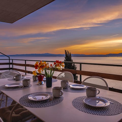 Enjoy the stunning view while the sun sets over the sparkling water