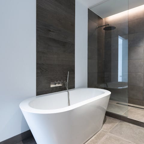 Unwind in the contemporary bathroom with a raw aesthetic at the end of a tiring day