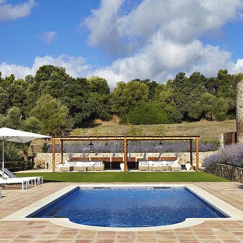Swim laps in the Roman-style swimming pool outside