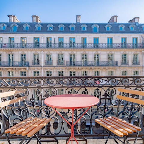 Admire the views over this Parisian street with a glass of Champagne