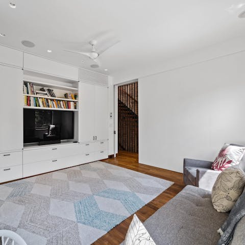 Take a moment to relax with a good book in the den