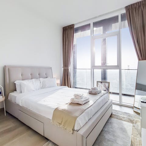 Sleep soundly in your comfortable bedroom with skyline views