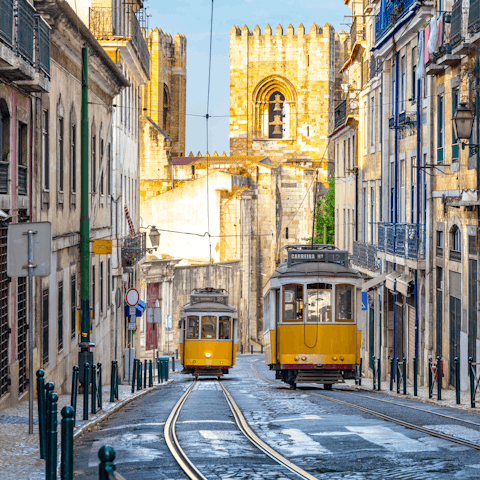 Take a ten-minute ride on the iconic yellow tram to reach the Praca de Comerco