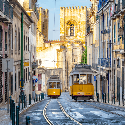 Take a ten-minute ride on the iconic yellow tram to reach the Praca de Comerco
