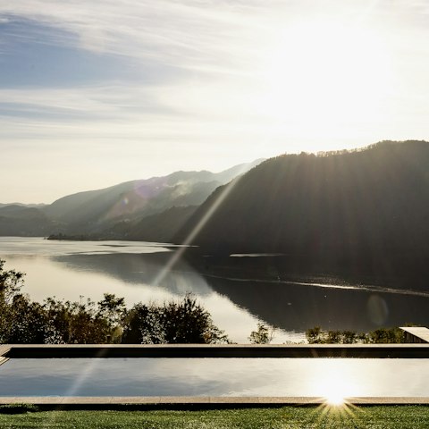 Go for a dip in the communal swimming pool boasting lake views