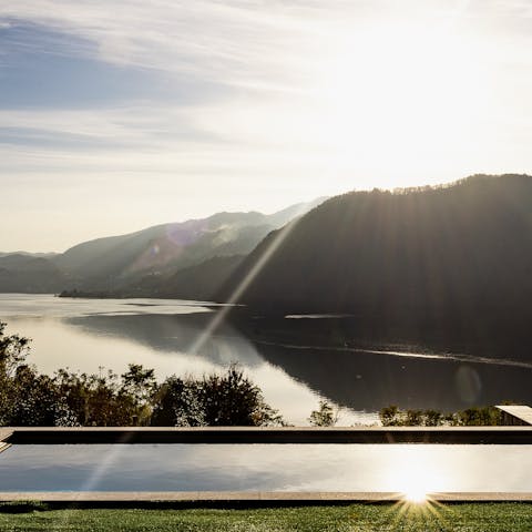Go for a dip in the communal swimming pool boasting lake views