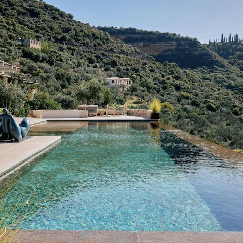 Swim unhurried laps in the private infinity pool overlooking the Messinian Gulf