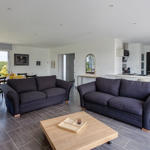 Get cosy in the light-filled living room, with two plush sofas and armchairs