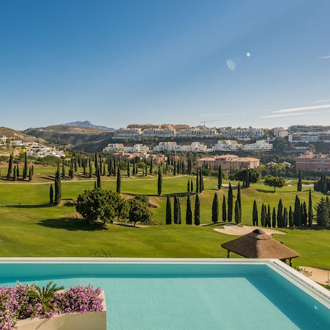Swim laps in the pool as you overlook the green of the golf course
