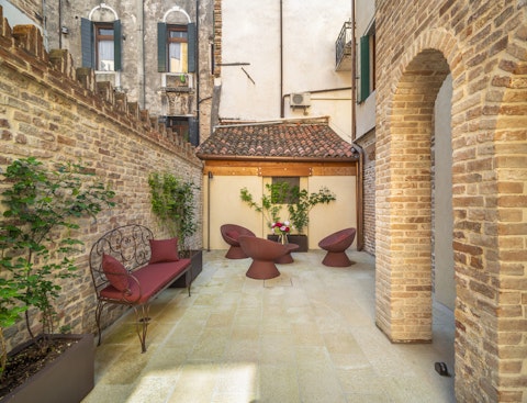 Settle into a secluded Venetian courtyard tucked away from the crowds